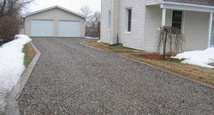 The bordered driveway unites the garage and the house. 