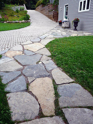 Permeable Turfstone stabilizes an eroding boat launch driveway. The lower limestone deck secures the driveway against runoff erosion.
